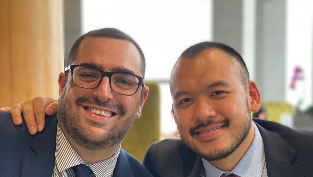 Two men in suit smiling