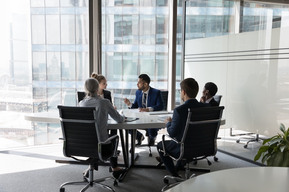 Team of colleagues holding a discussion around a table